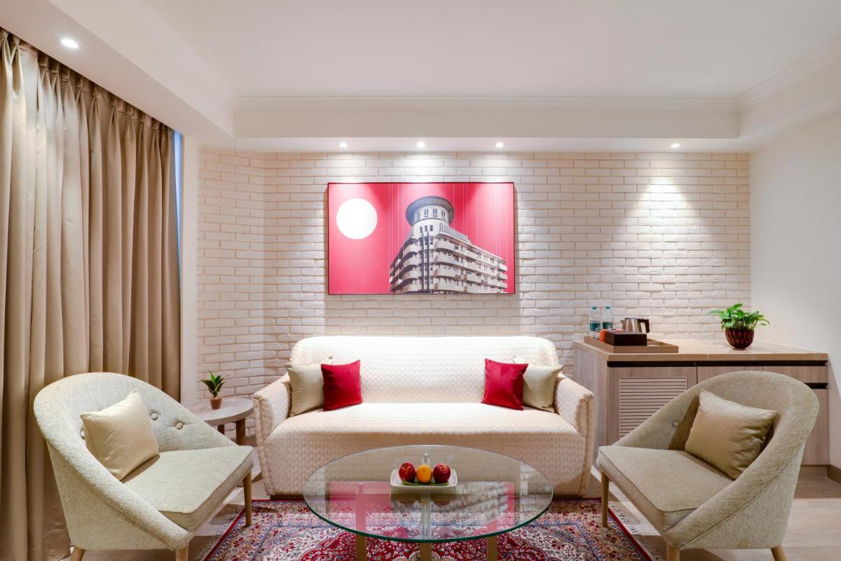 a living room with a couch and two chairs and a table at Lemon Tree Premier, Mumbai International Airport in Mumbai