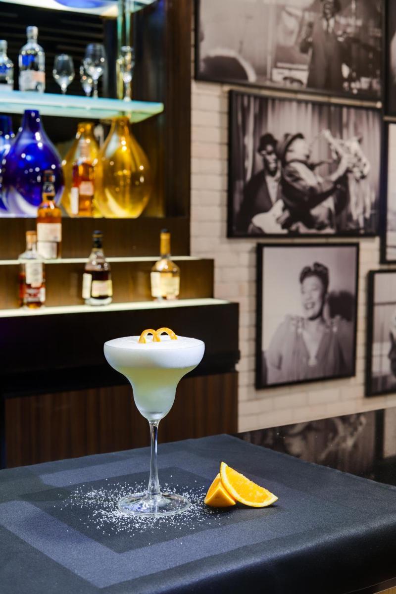 a martini glass sitting on top of a table at Lemon Tree Premier, Mumbai International Airport in Mumbai