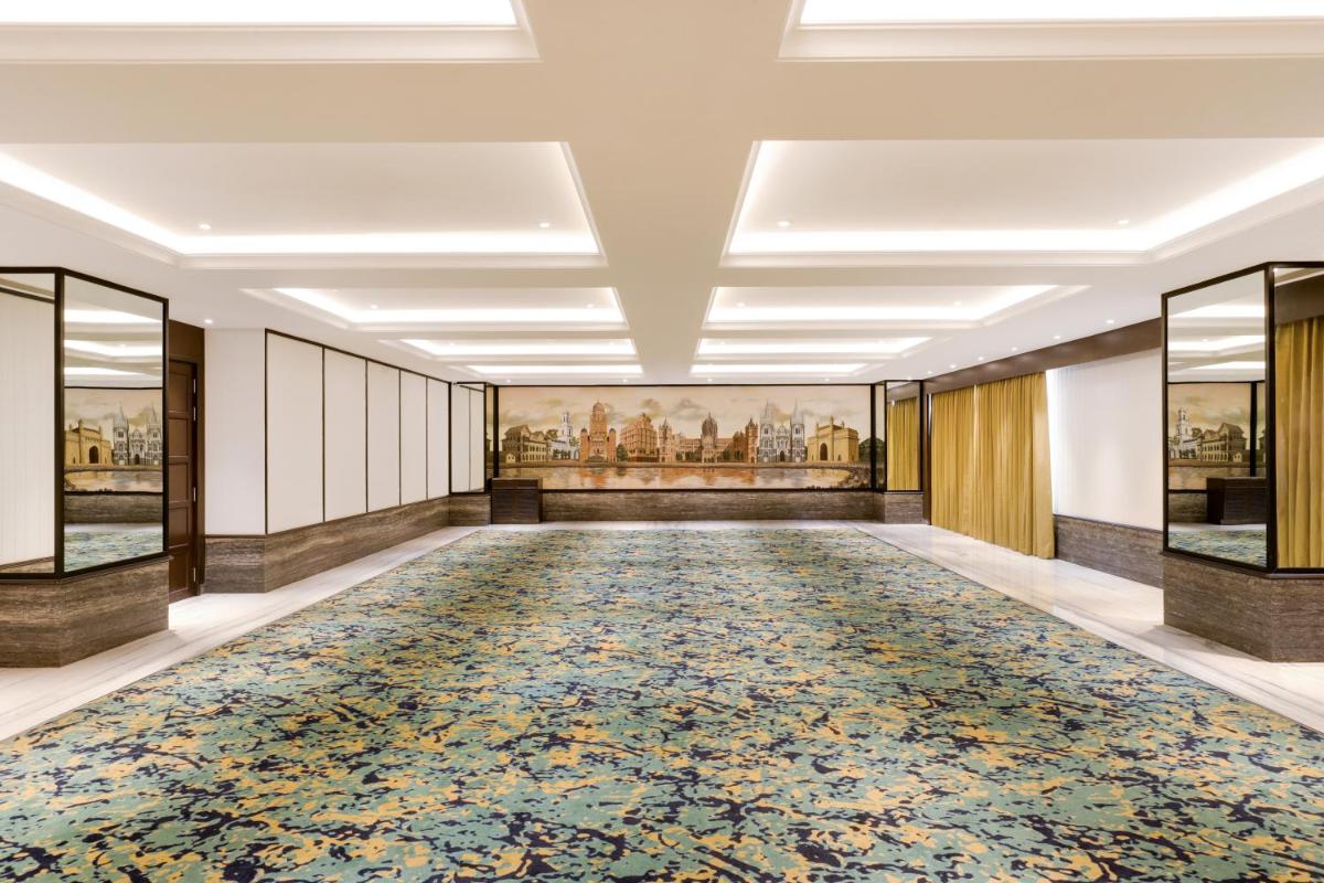 an aisle in a building with a large rug at Lemon Tree Premier, Mumbai International Airport in Mumbai