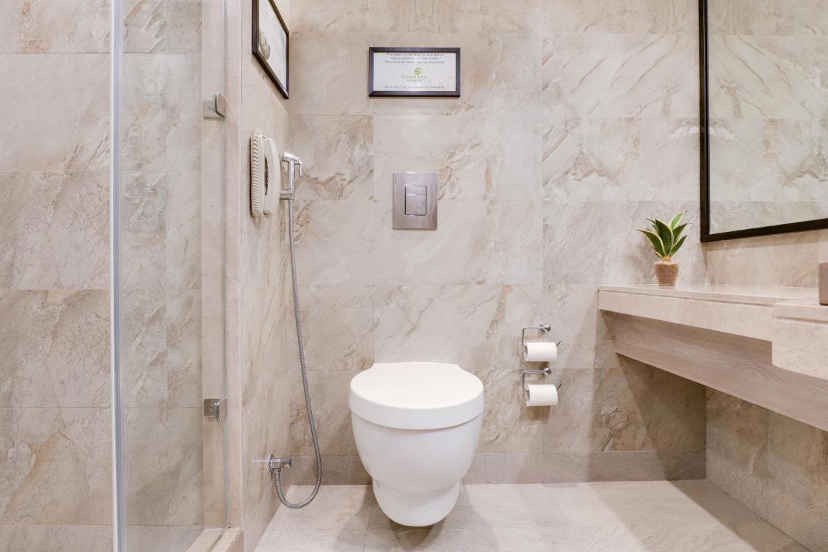 a bathroom with a toilet and a shower at Lemon Tree Premier, Mumbai International Airport in Mumbai