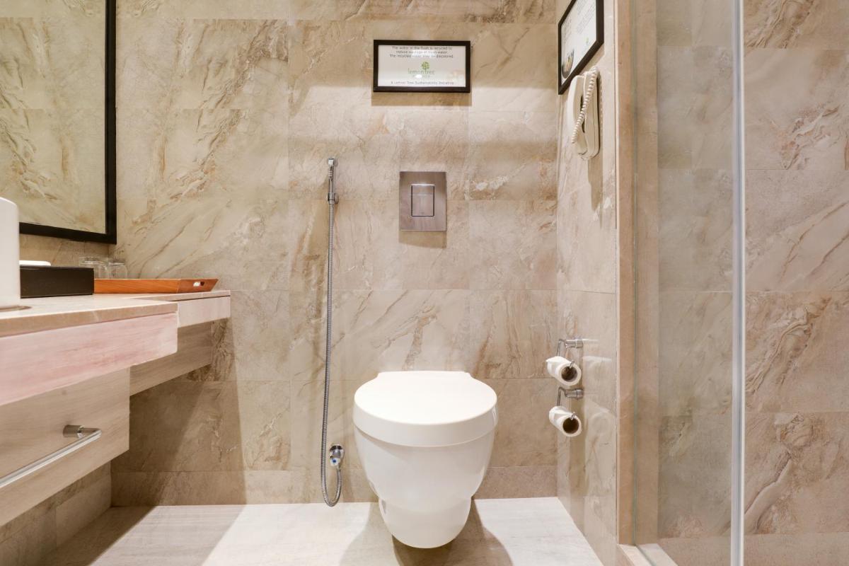 a bathroom with a toilet and a shower at Lemon Tree Premier, Mumbai International Airport in Mumbai
