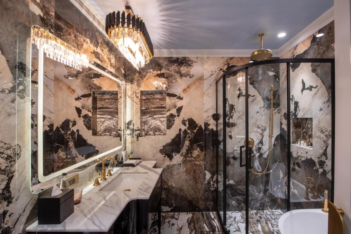 a bathroom with a shower and a sink at The Claridges New Delhi in New Delhi a bathroom with a shower and a sink at The Claridges New Delhi in New Delhi