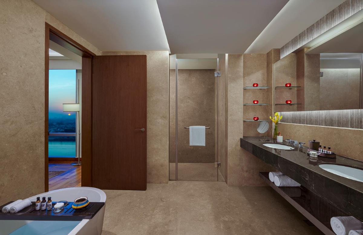 a bathroom with two sinks and a shower at Hyatt Regency Ahmedabad in Ahmedabad