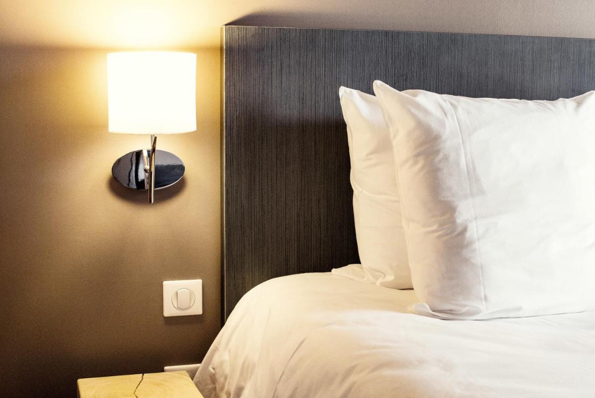 Un ou plusieurs lits dans un hébergement de l'établissement SOWELL HOTELS Le Parc & Spa