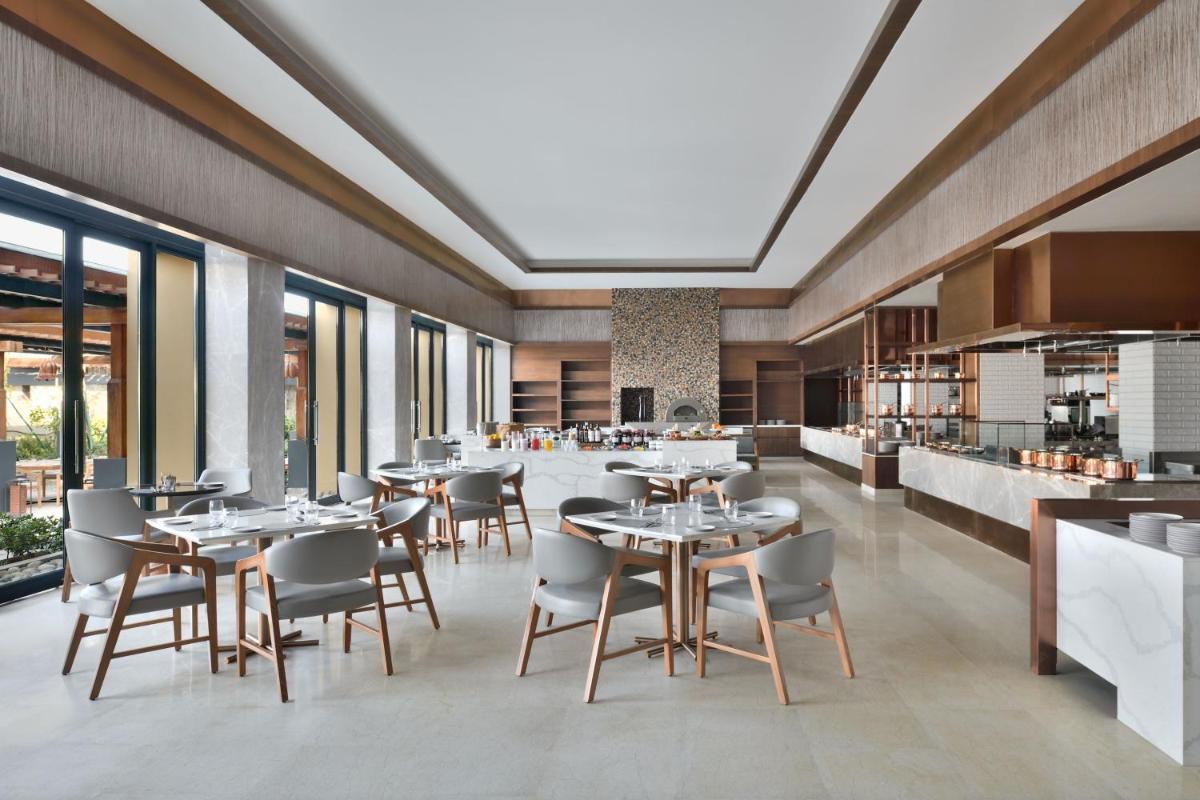 a dining room with tables and chairs in a restaurant at The Westin Resort & Spa Himalayas in Rishīkesh