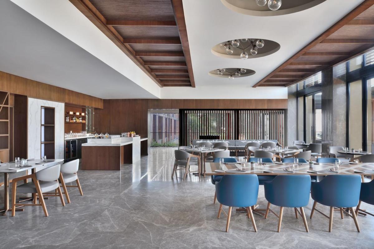 a rendering of a restaurant with tables and chairs at The Westin Resort & Spa Himalayas in Rishīkesh