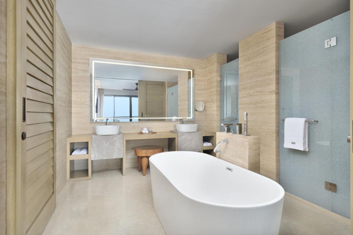 a bathroom with a tub and a sink and a mirror at The Westin Resort & Spa Himalayas in Rishīkesh