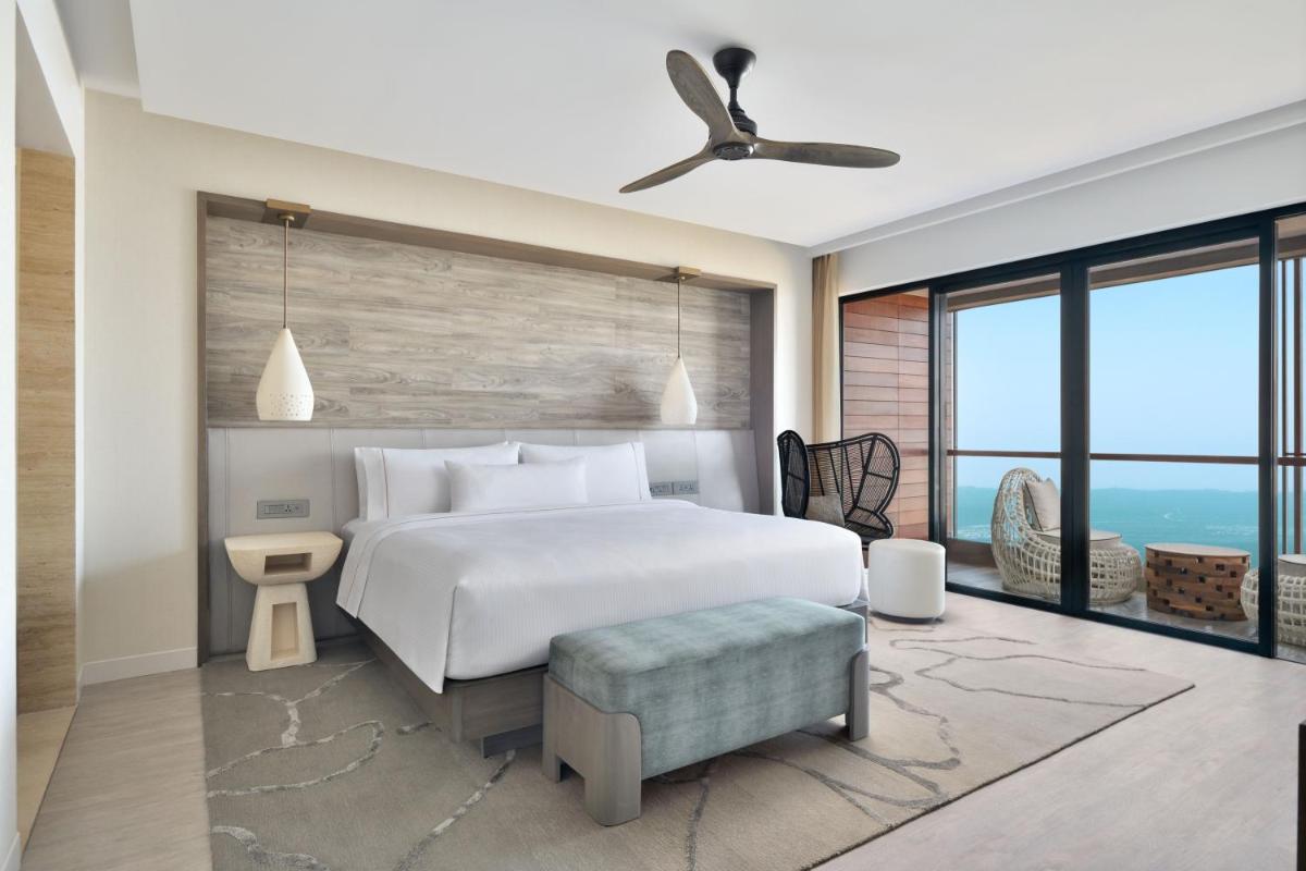 a bedroom with a white bed and a large window at The Westin Resort & Spa Himalayas in Rishīkesh