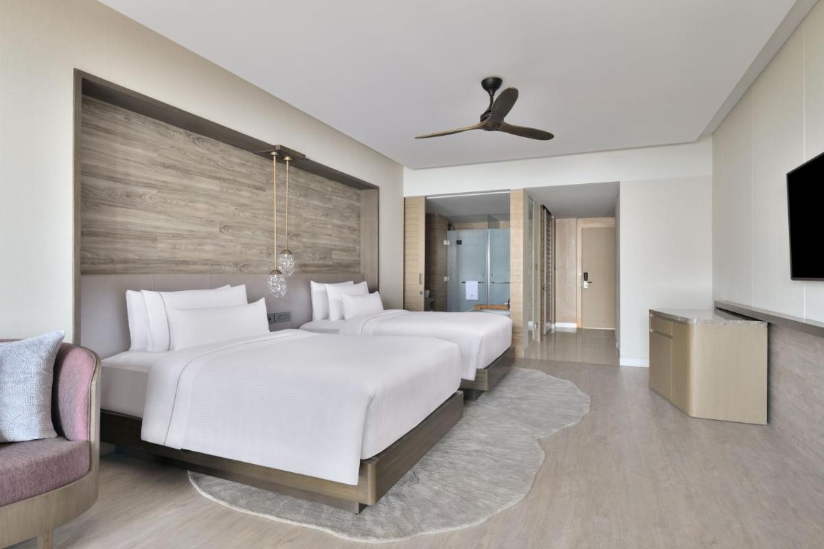 a hotel room with two beds and a tv at The Westin Resort & Spa Himalayas in Rishīkesh