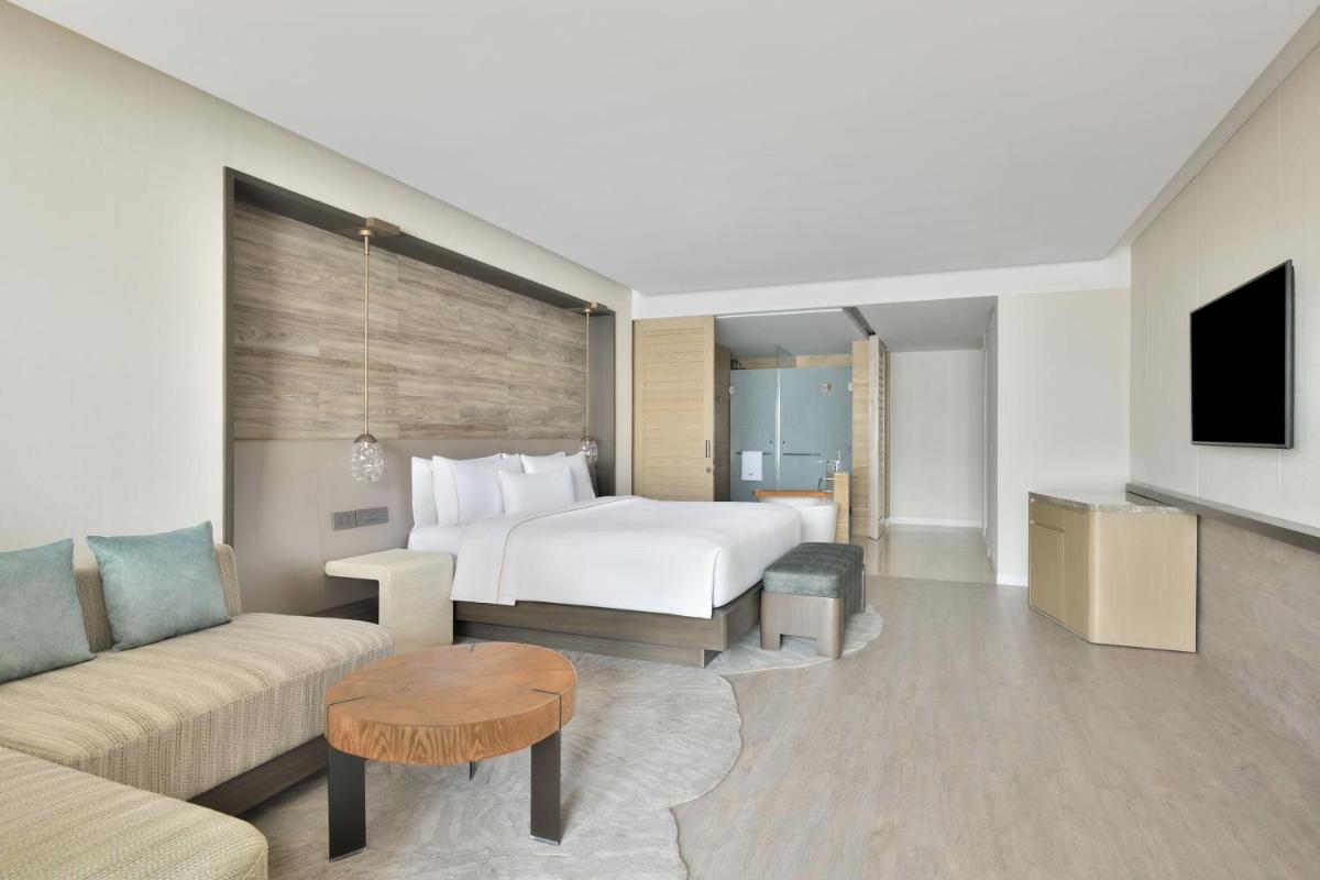 a hotel room with a bed and a couch at The Westin Resort & Spa Himalayas in Rishīkesh