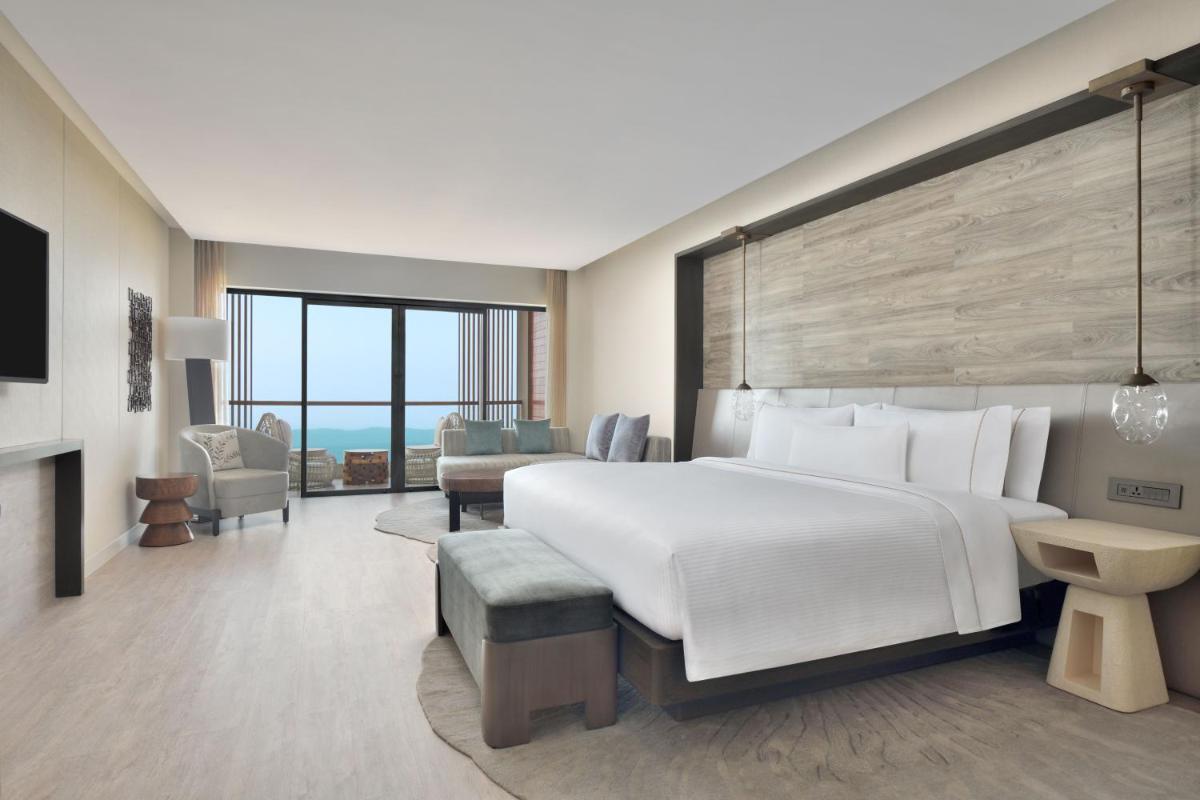 a bedroom with a large bed and a living room at The Westin Resort & Spa Himalayas in Rishīkesh