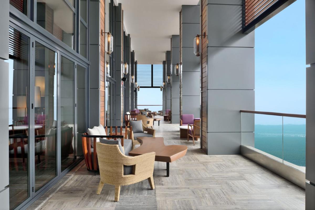 a lobby of a hotel with chairs and tables at The Westin Resort & Spa Himalayas in Rishīkesh