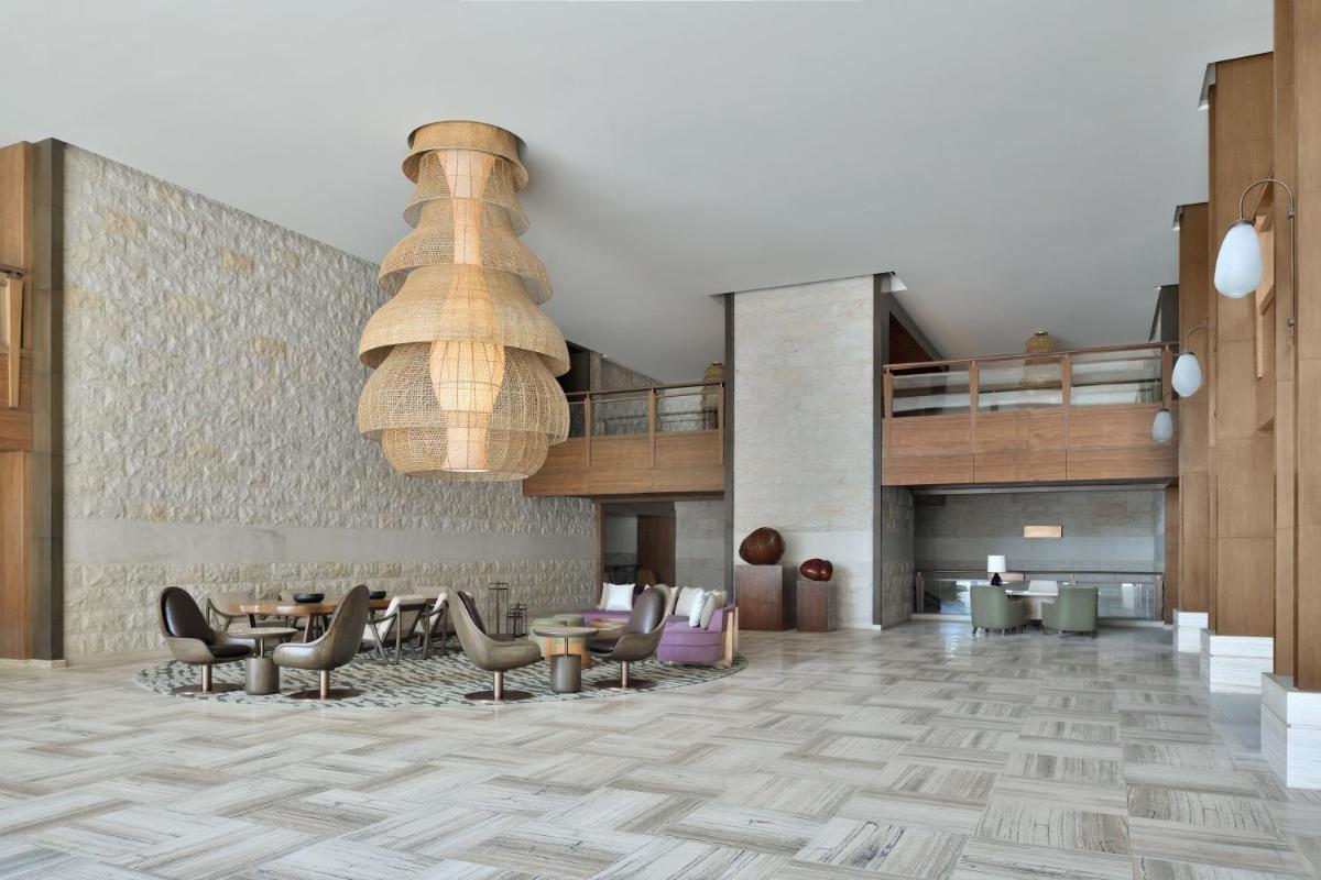 a lobby of a hotel with chairs and tables at The Westin Resort & Spa Himalayas in Rishīkesh