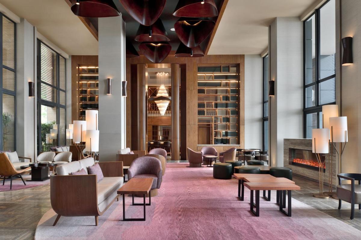 a lobby with couches and chairs and a fireplace at The Westin Resort & Spa Himalayas in Rishīkesh