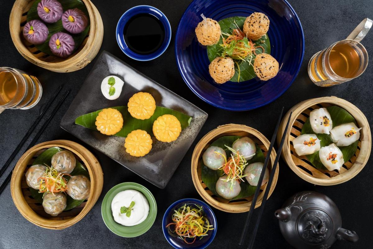 a table with bowls of food and plates of food at Hyatt Regency Delhi in New Delhi a table with bowls of food and plates of food at Hyatt Regency Delhi in New Delhi