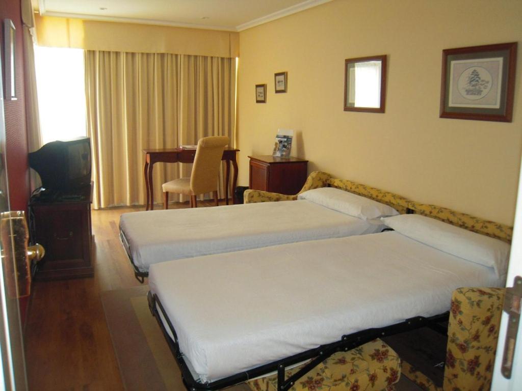 Cama o camas de una habitación en Silken Spa La Hacienda De Don Juan