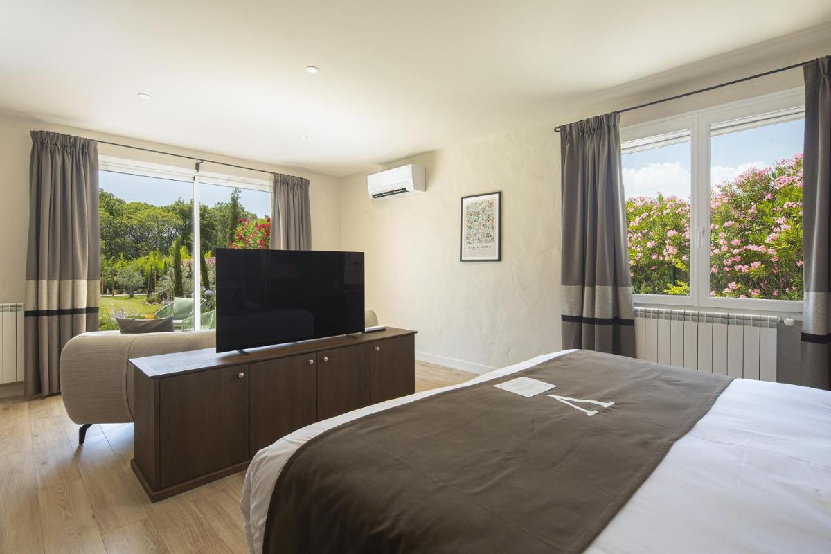 Un ou plusieurs lits dans un hébergement de l'établissement Le Vallon de Valrugues Hotel Spa & Villas