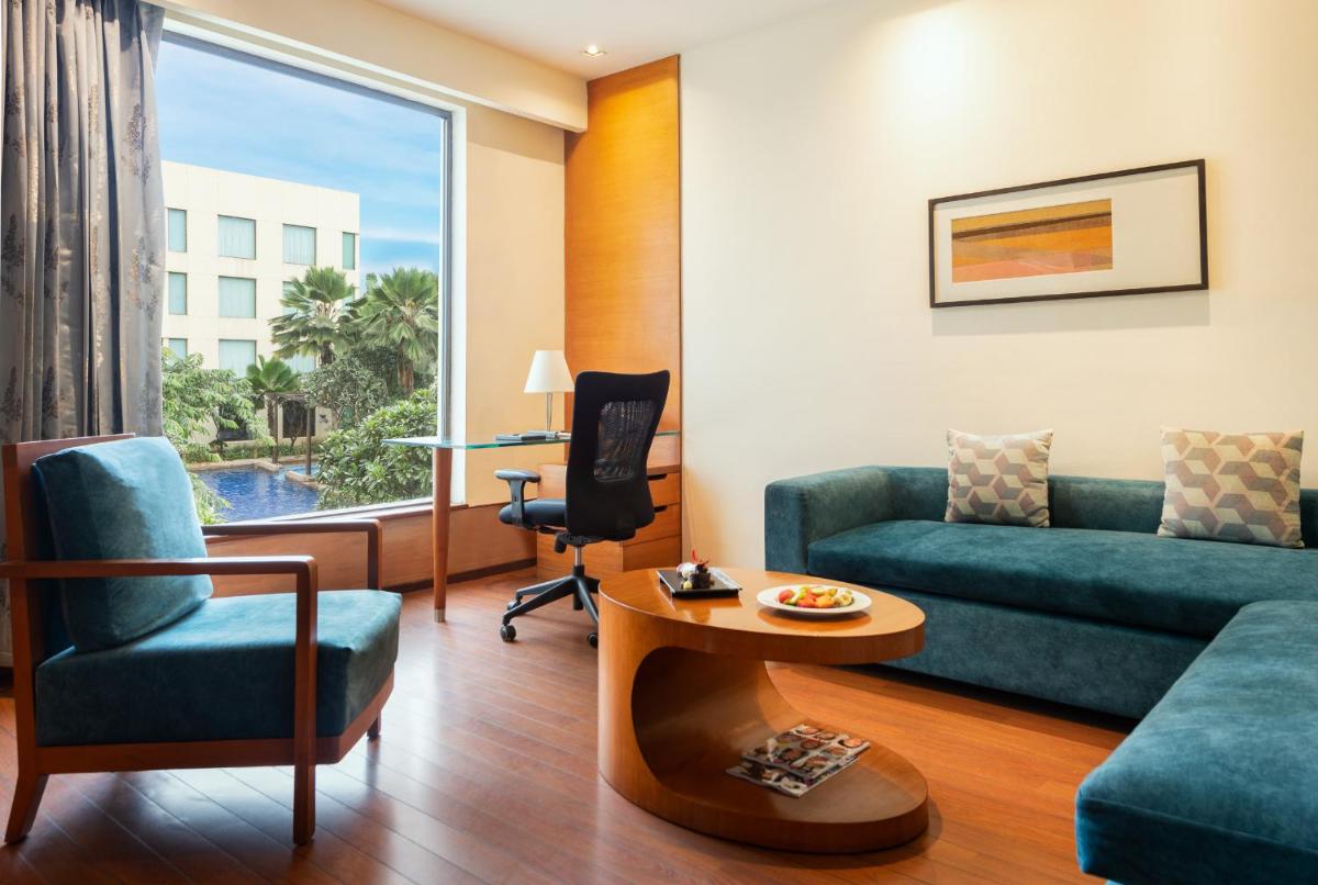 a living room with a couch and a table at Hyatt Pune in Pune