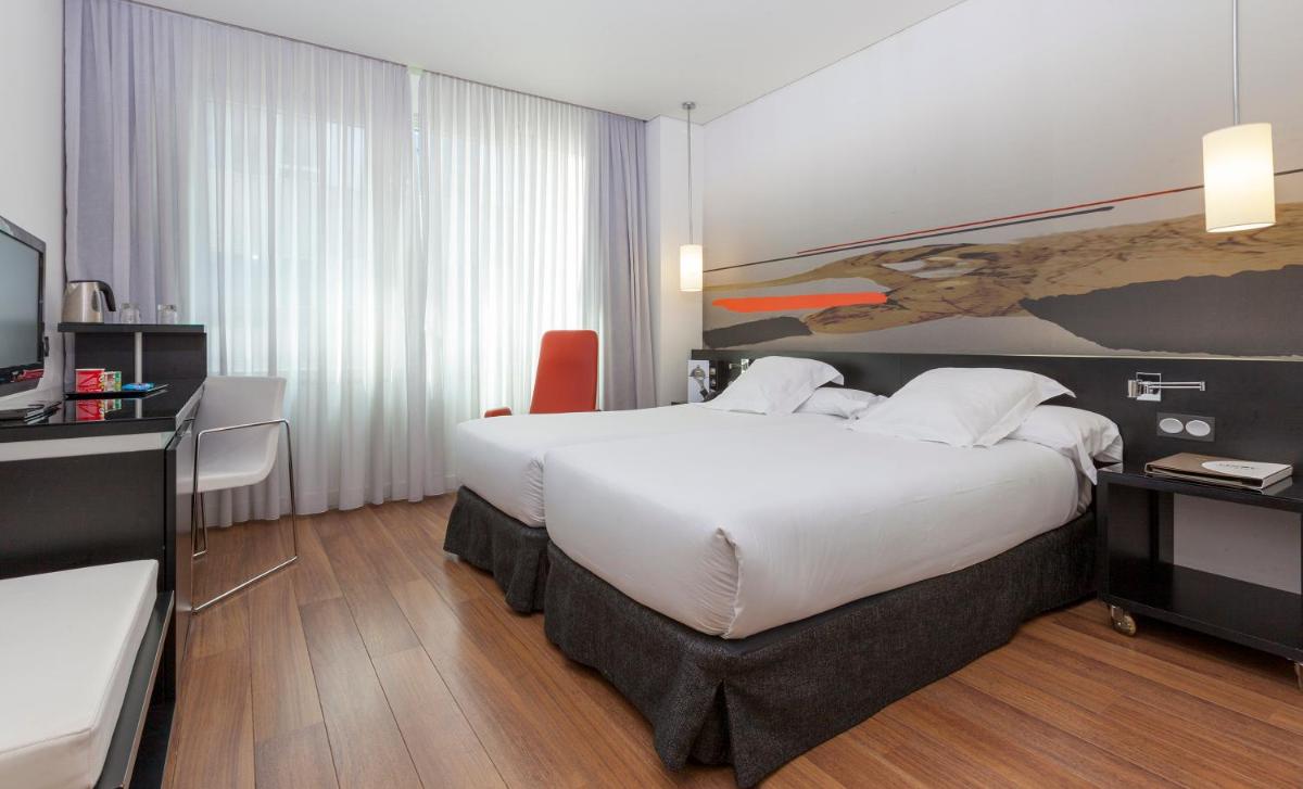 Cama o camas de una habitación en Axor Barajas