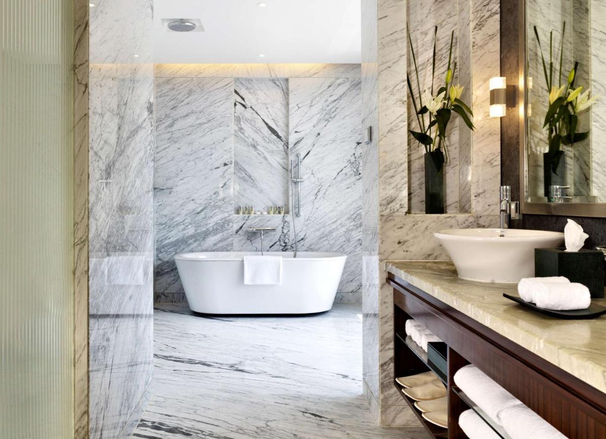 a bathroom with a tub and a sink at Hyatt Regency Pune Hotel & Residences in Pune