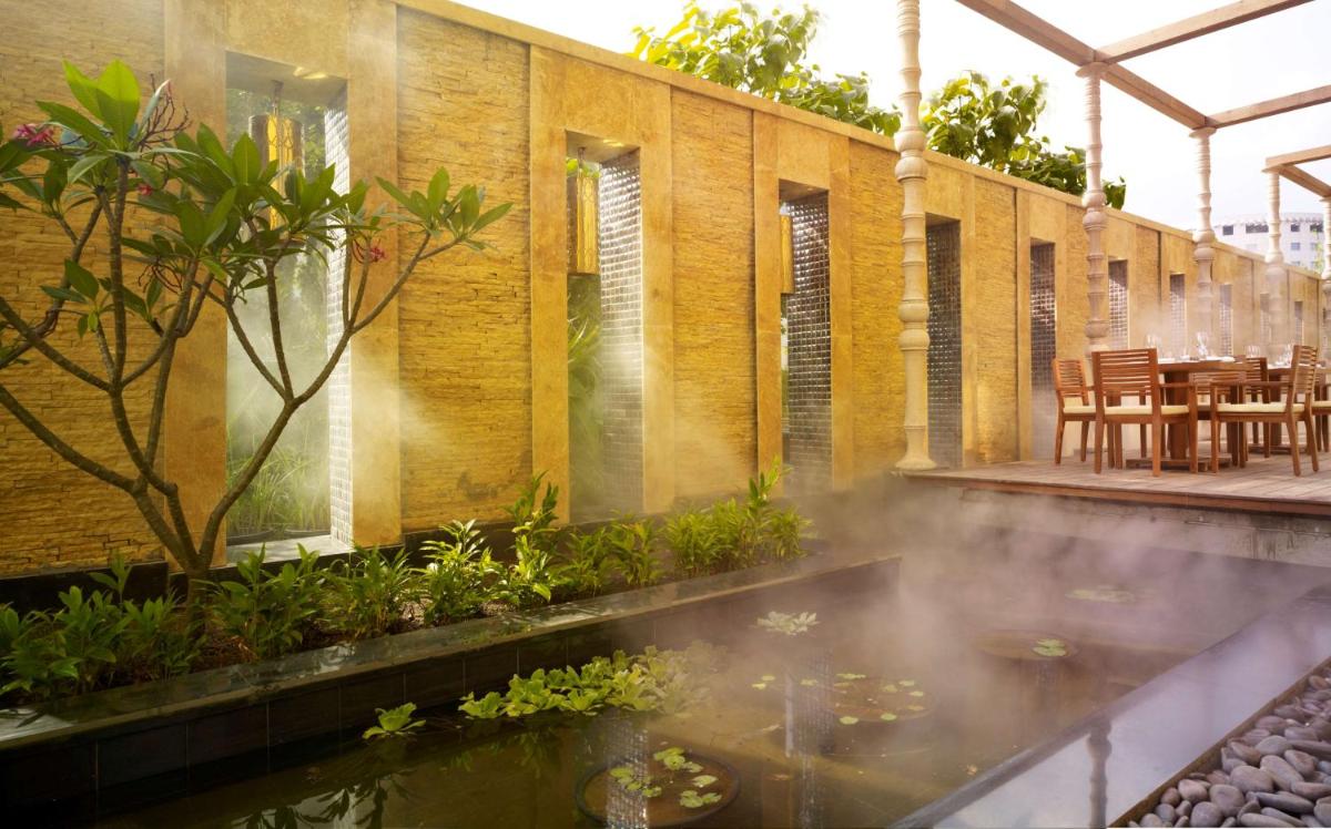 a house with a pond in front of a building at Hyatt Regency Pune Hotel & Residences in Pune