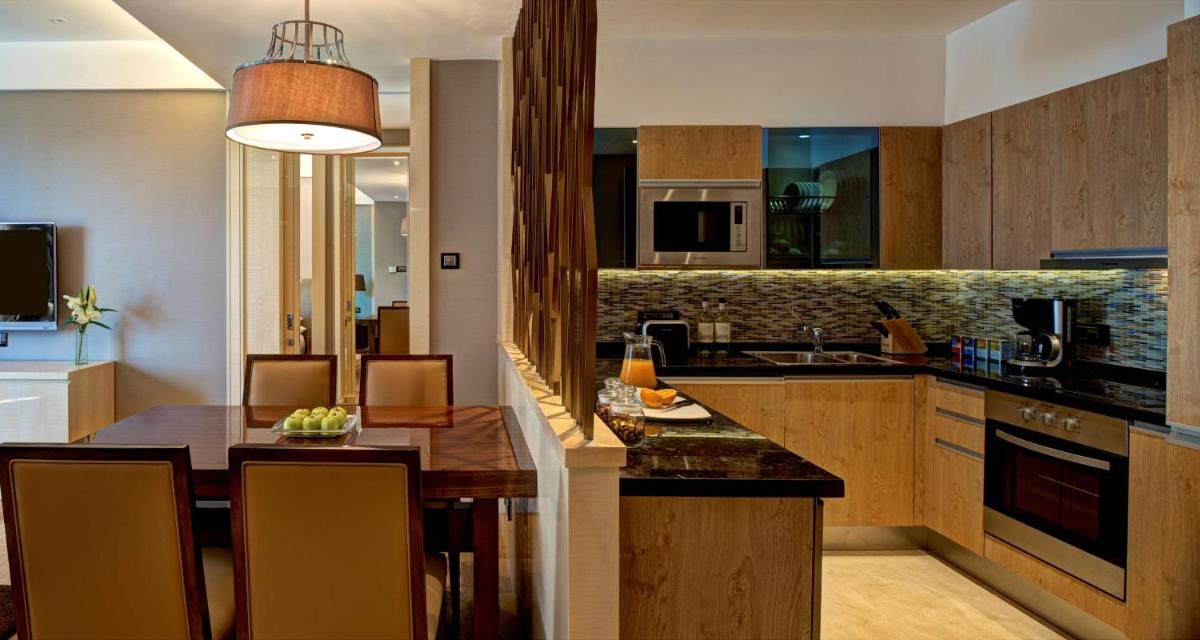 a kitchen and dining room with a dining table at Hyatt Regency Pune Hotel & Residences in Pune