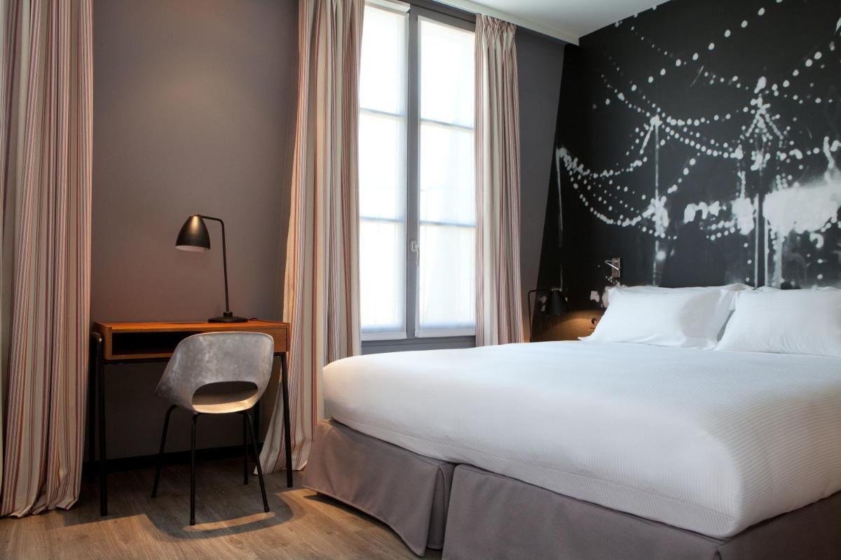 Un ou plusieurs lits dans un hébergement de l'établissement Hotel L’Antoine