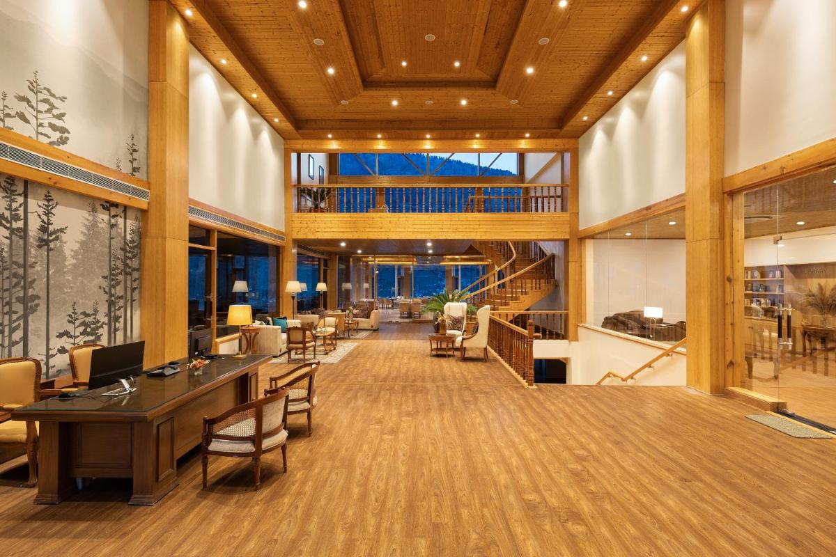 a large lobby with a long table and chairs at Baragarh Resort & Spa, Manali- IHCL SeleQtions in Manāli