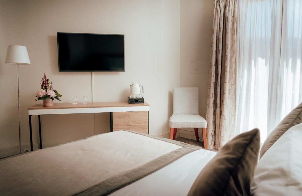 Un ou plusieurs lits dans un hébergement de l'établissement Ermitage de l'Oasis & Spa - Cannes Mandelieu