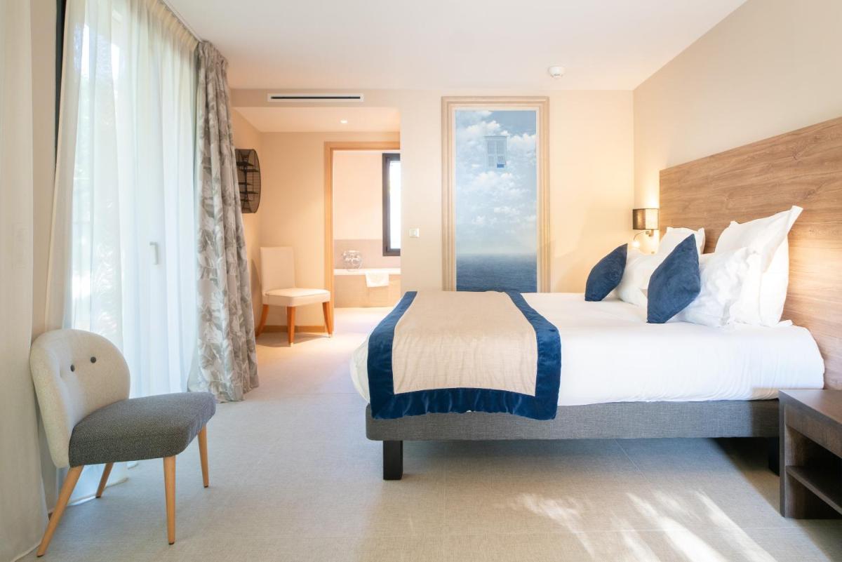 Un ou plusieurs lits dans un hébergement de l'établissement Ermitage de l'Oasis & Spa - Cannes Mandelieu