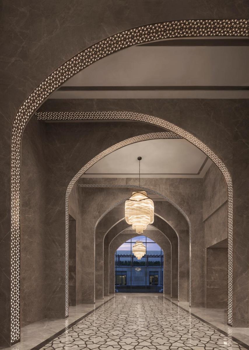an archway in a building with a chandelier at Taj Amer, Jaipur in Jaipur