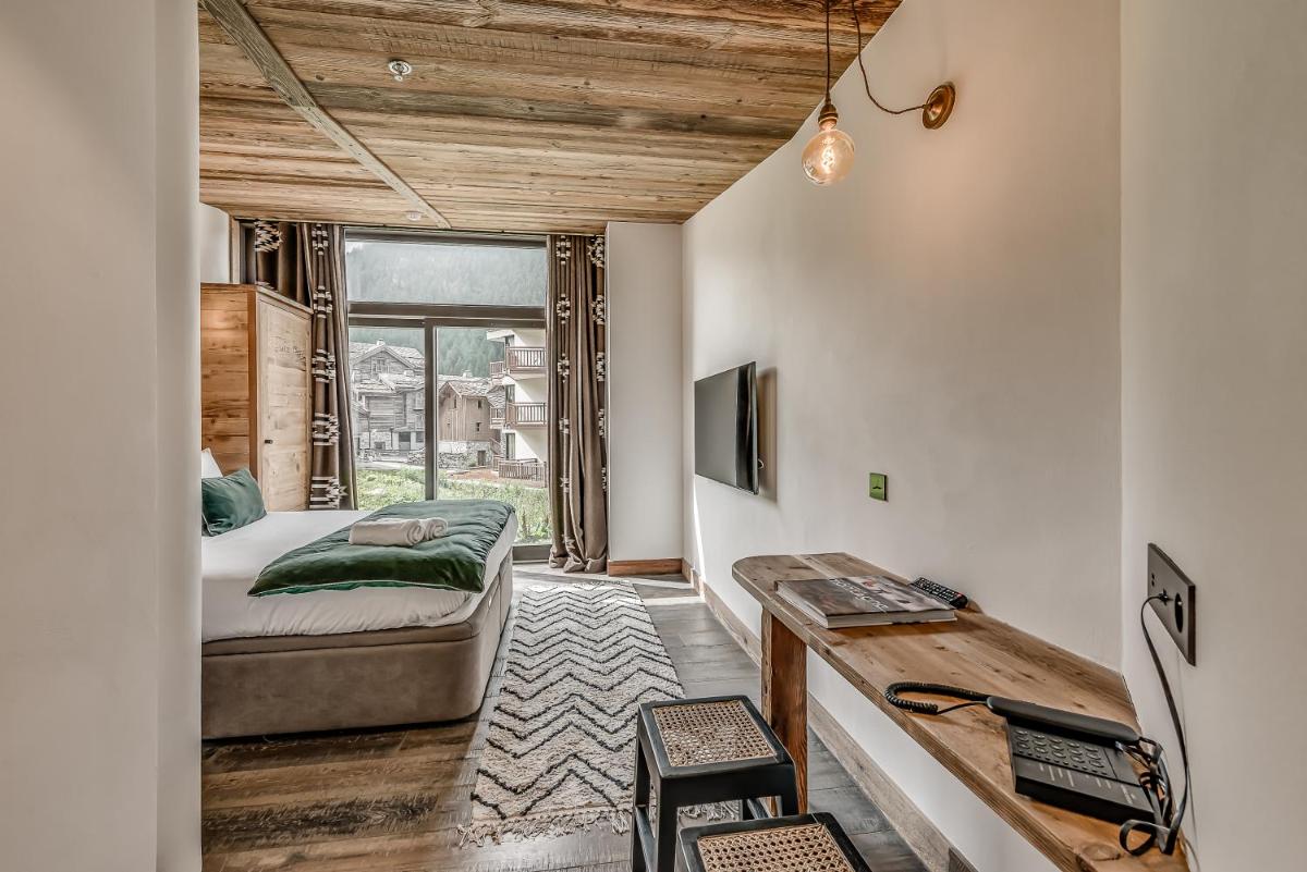 Un ou plusieurs lits dans un hébergement de l'établissement Hotel & Spa Le Val d'Isère