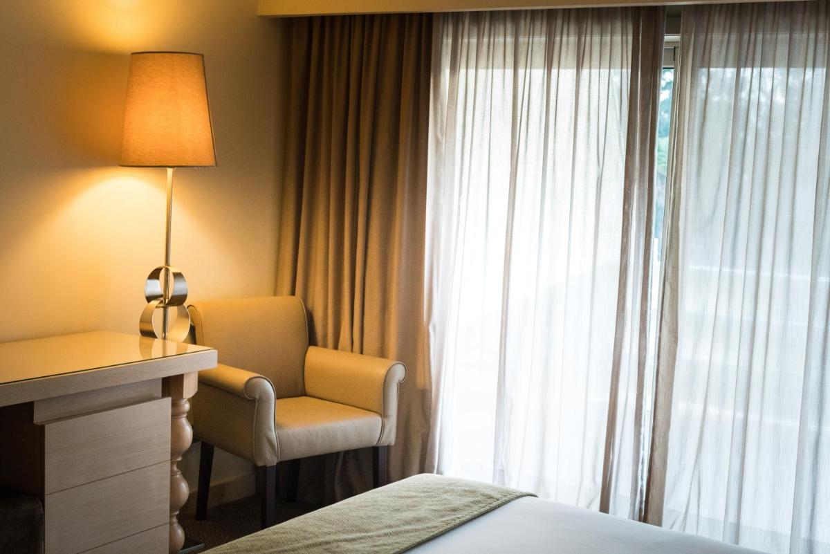 Uma cama ou camas num quarto em Hotel Porta do Sol Conference & SPA