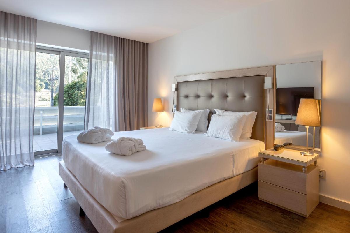 Uma cama ou camas num quarto em Hotel Porta do Sol Conference & SPA