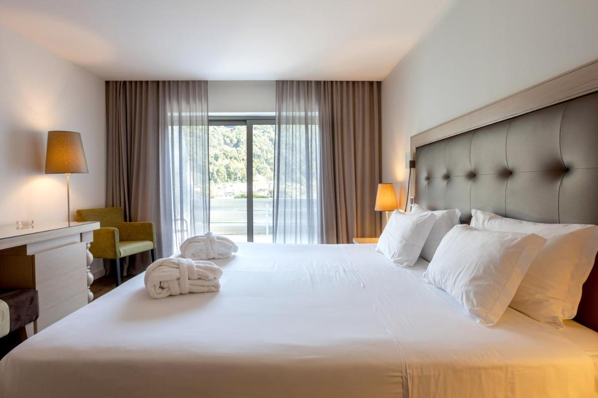 Uma cama ou camas num quarto em Hotel Porta do Sol Conference & SPA