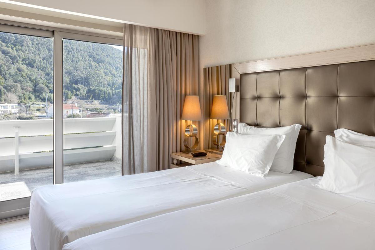Uma cama ou camas num quarto em Hotel Porta do Sol Conference & SPA