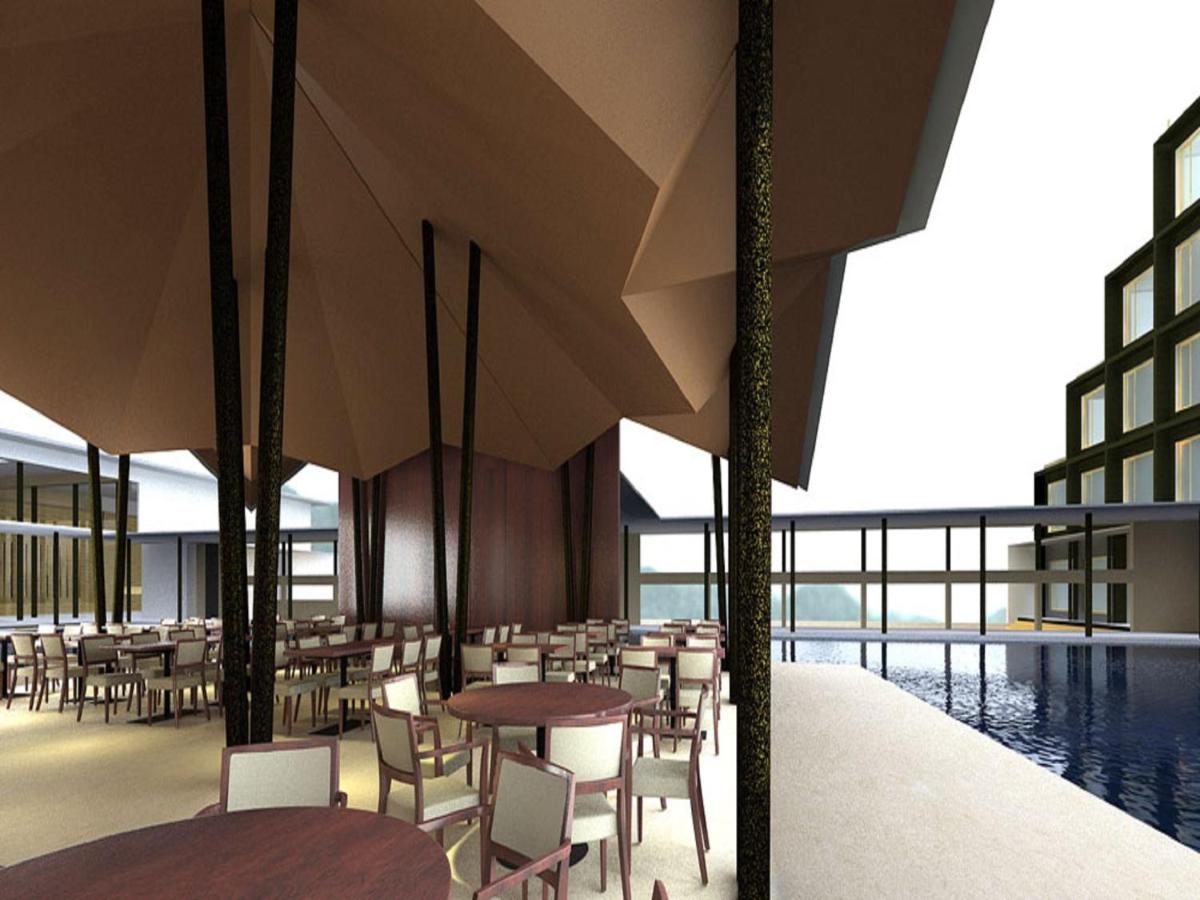 a restaurant with tables and chairs and a pool at Marasa Sarovar Premiere in Tirupati