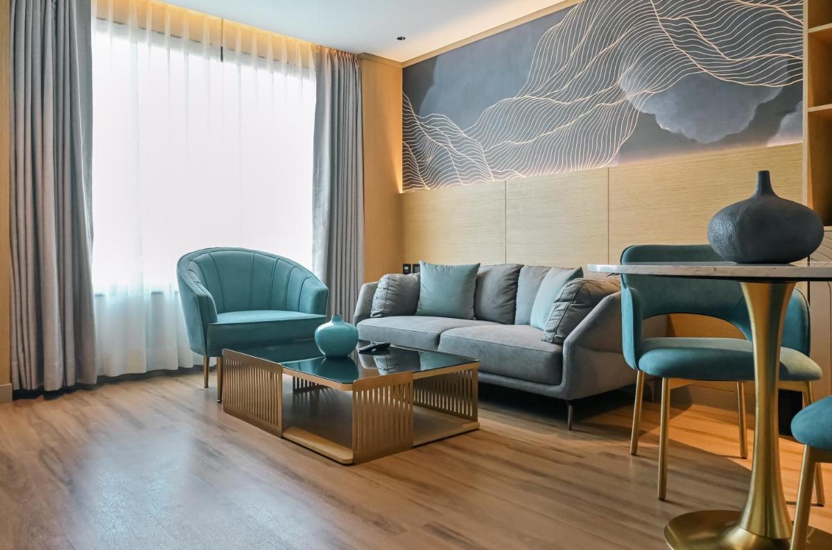 a living room with a couch and a table and chairs at Parallel Hotel Udaipur, a member of Radisson Individuals in Udaipur