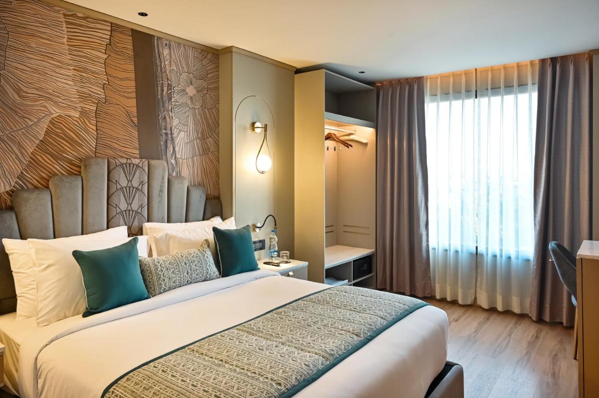 a hotel room with a large bed and a window at Parallel Hotel Udaipur, a member of Radisson Individuals in Udaipur
