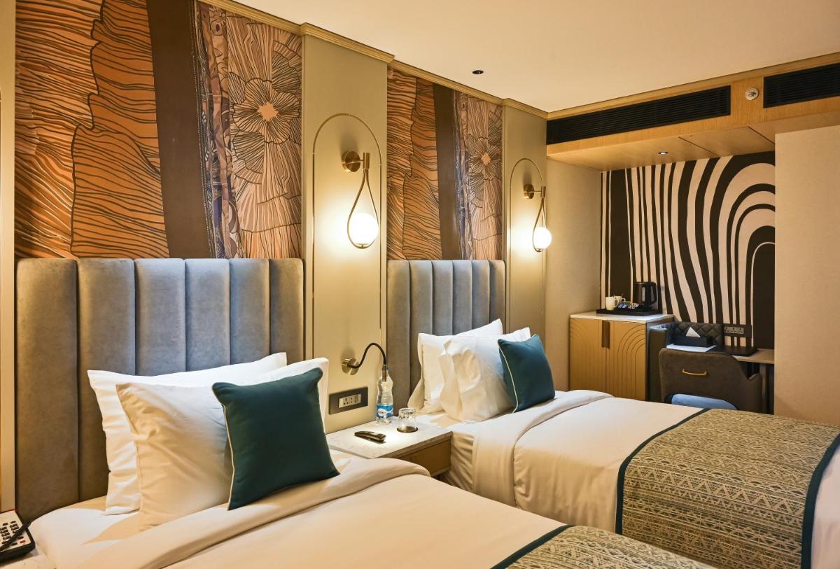 a hotel room with two beds in a room at Parallel Hotel Udaipur, a member of Radisson Individuals in Udaipur +167 photos