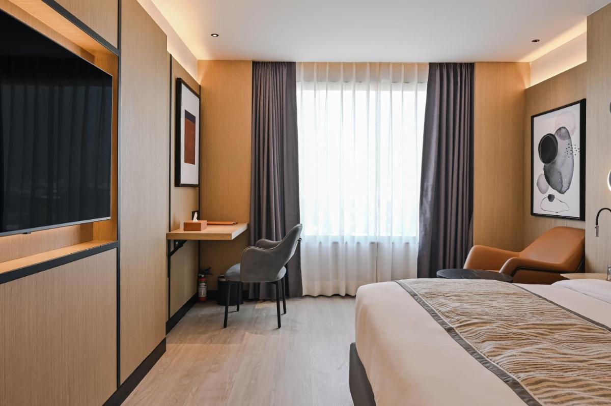 a hotel room with a bed and a television at Parallel Hotel Udaipur, a member of Radisson Individuals in Udaipur