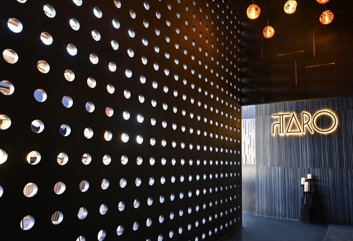 a wall with a lit up sign on it at Parallel Hotel Udaipur, a member of Radisson Individuals in Udaipur