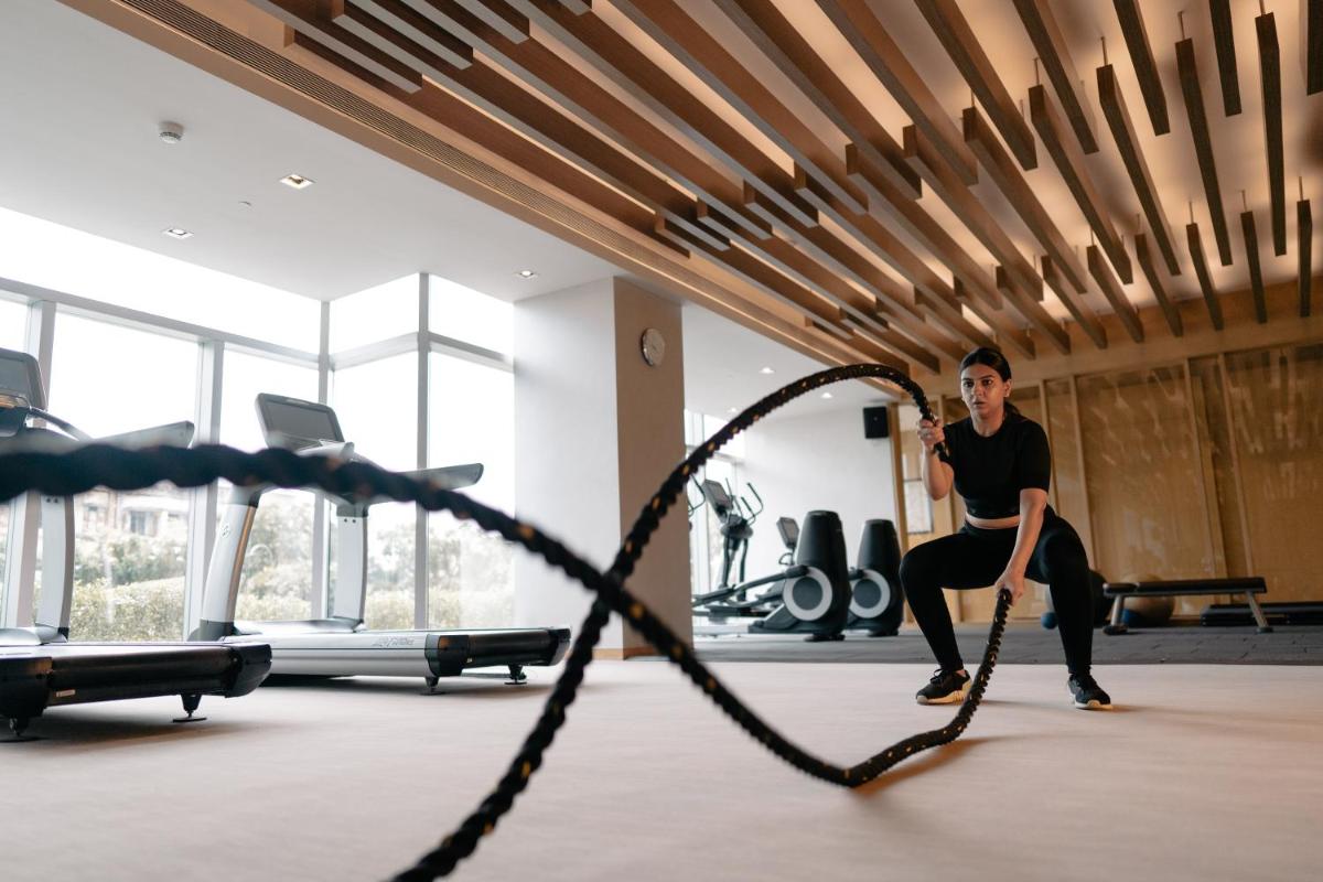 a man in a gym with a skipping rope at Hyatt Regency Ahmedabad in Ahmedabad