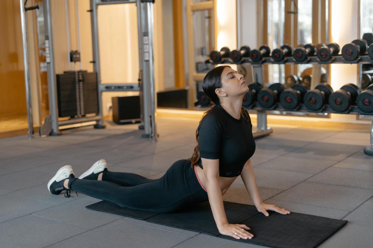 a woman doing a plank in a gym at Hyatt Regency Ahmedabad in Ahmedabad