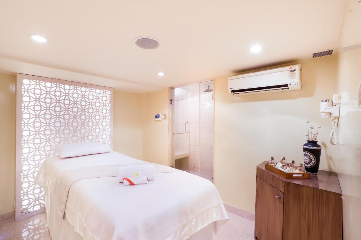a bedroom with a white bed and a shower at Lemon Tree Premier, Ulsoor Lake, Bengaluru in Bengaluru