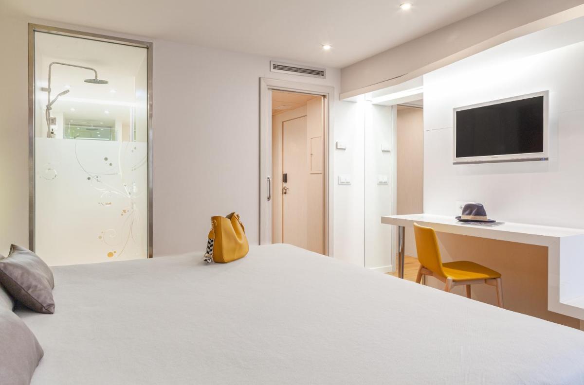 Cama o camas de una habitación en Hotel Maciá Granada Five Senses Rooms & Suites