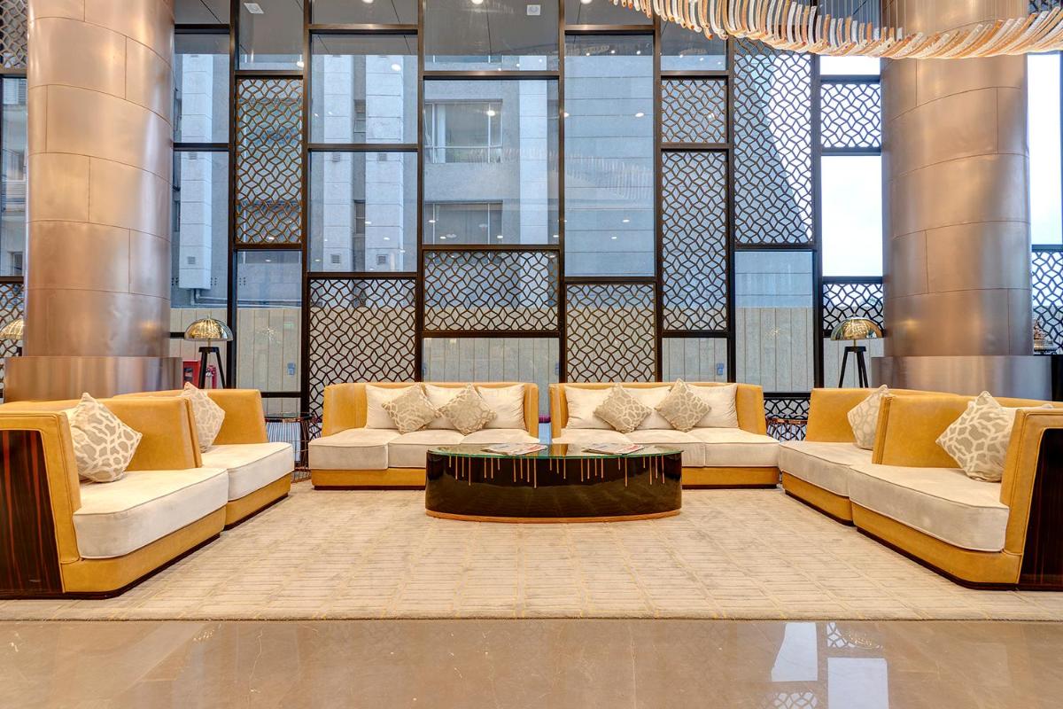 a lobby with two couches and a coffee table at Holiday Inn Kolkata Airport by IHG in Kolkata