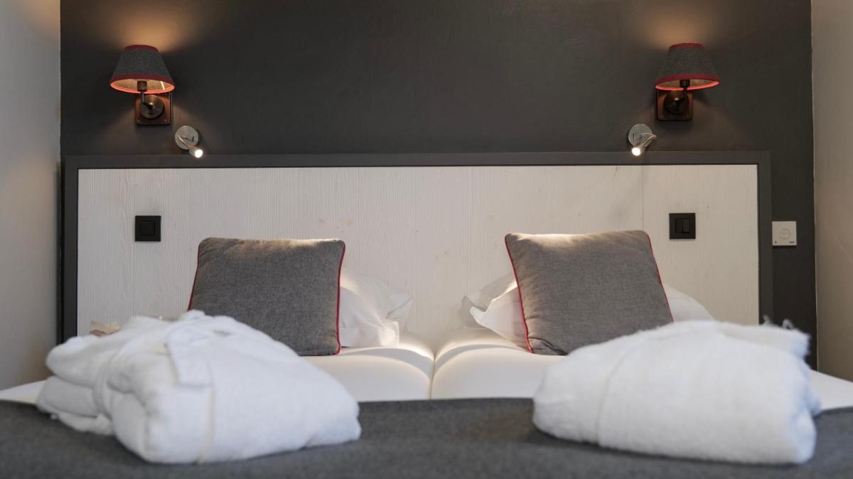Un ou plusieurs lits dans un hébergement de l'établissement Le Faucigny - Hotel de Charme & SPA