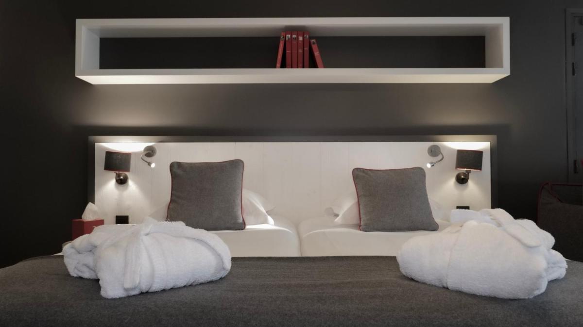 Un ou plusieurs lits dans un hébergement de l'établissement Le Faucigny - Hotel de Charme & SPA
