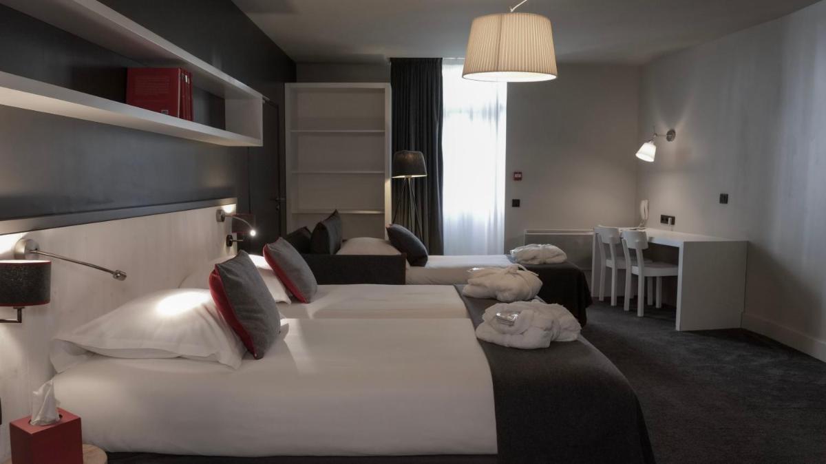 Un ou plusieurs lits dans un hébergement de l'établissement Le Faucigny - Hotel de Charme & SPA
